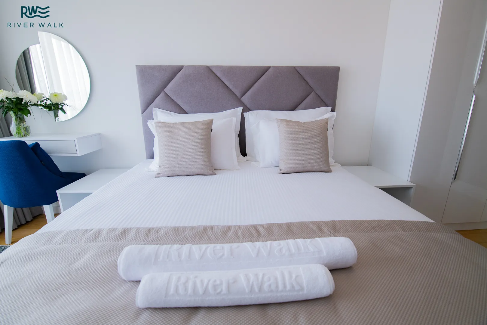 River Walk embroidered towels on a made bed